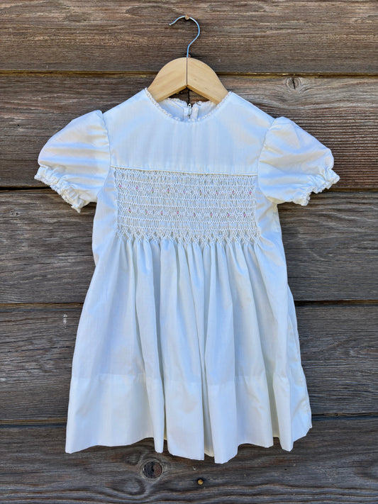 White smocked baby dress